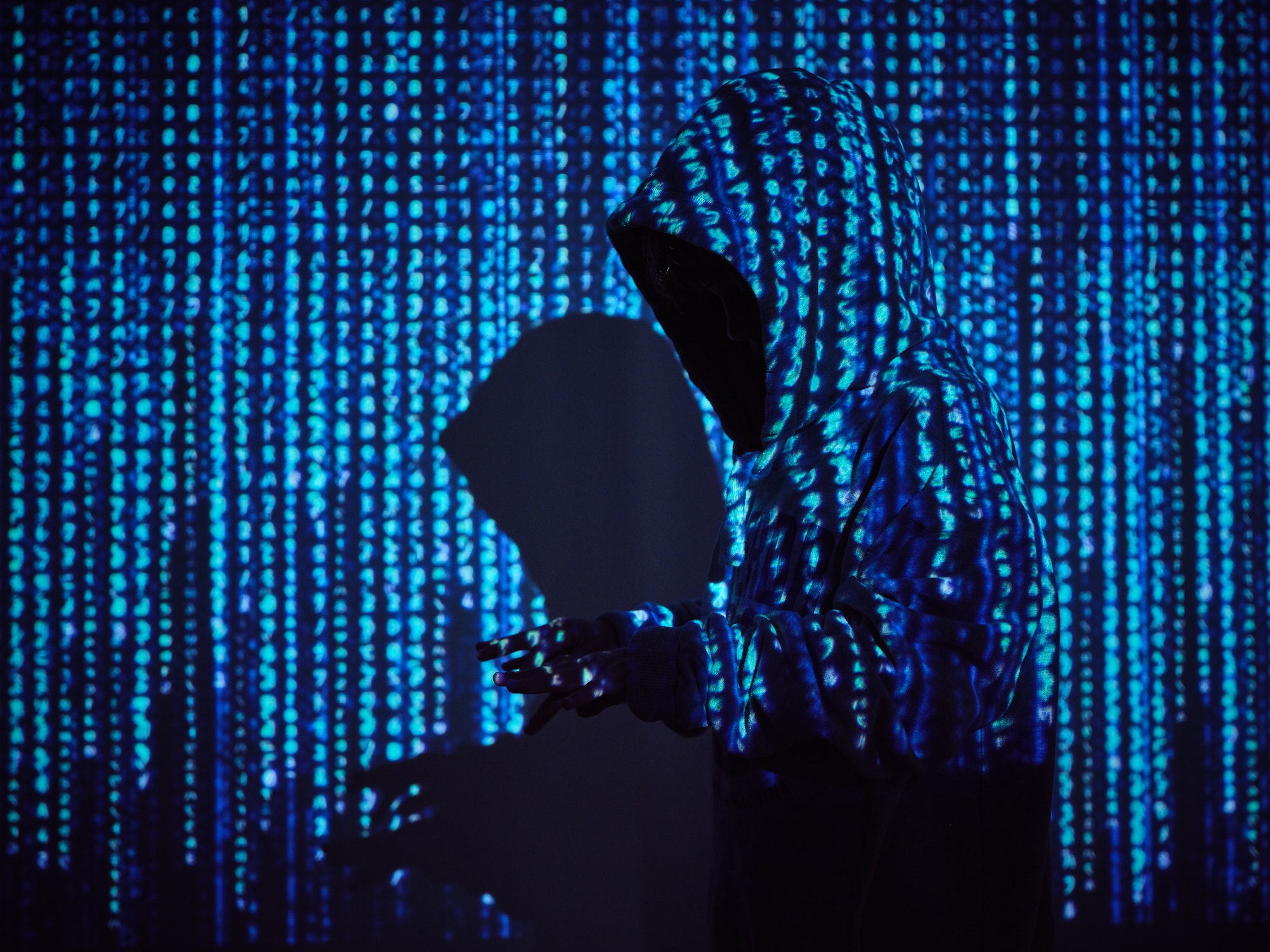 Hacker in binary code projection